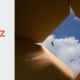 Der Blick aus dem Inneren eines offenen Kartons hinauf in den sonnigen Himmel mit einem frei fliegenden Vogel visualisiert den befreienden Perspektivwechsel, um Probleme mit Abstand betrachten zu können.